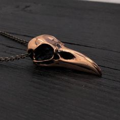 Discover the intricate beauty of my Raven Skull Pendant Necklace, one of my oldest original designs and a personal favorite. This captivating piece has been crafted for several years, but now I present it in a new form: solid jeweler's grade silicon bronze and a smaller, more delicate size. Originally measuring 2-1/4", I meticulously shrank the raven skull to 1-5/8" without losing any of its perfect proportions and intricate details. The result is a beautifully detailed miniature bird skull that Bronze Skull-shaped Jewelry Gift, Bronze Skull Jewelry For Gifts, Bronze Skull Jewelry Gift, Bird Skull Jewelry, Raven Skull Necklace, Caged Necklace, Skull Pendant Necklace, Raven Skull, Necklace Quotes