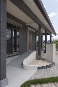 a modern house with stone steps leading up to the front door