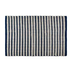 a blue and white rug with small squares on the bottom, in front of a white background