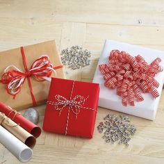 three presents wrapped in red and white paper