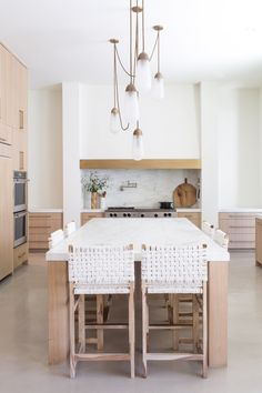 a large kitchen with an island in the middle