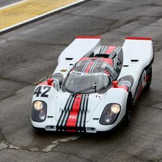 a white race car with red and black stripes