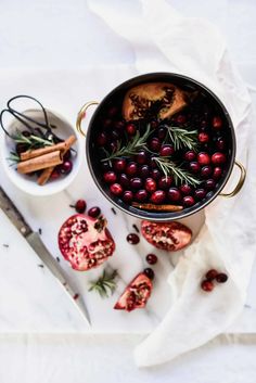 a pot filled with cranberry sauce next to other food on top of a table