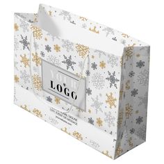 a paper bag with snowflakes on it and a tag that says your logo