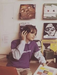 a person sitting at a desk with headphones on