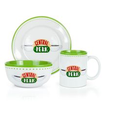 the central perk logo is on this green and white dinnerware set with matching mugs