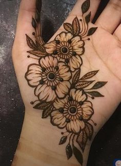 a woman's hand with flowers on it