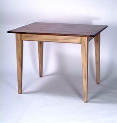 a wooden table sitting on top of a white floor