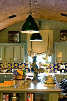 a kitchen with green cabinets and an arched ceiling