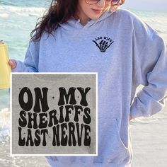 Sheriff Wife Crewneck, Hoodie, Long Sleeve Tee or T-shirt is the perfect custom gift for a law enforcement officer's wife or wife to be!  If you want the front pocket personalized, enter it in the personalization box. (Ex: Mrs. Smith) If left blank, "Leo Wife" will print on the front pocket. T-shirt: This is made with the Bella & Canvas 3001 classic unisex jersey short sleeve tee.  It fits like a well-loved favorite, soft cotton and quality print make users fall in love with it over and over aga Fiance Sweatshirt, Lineman Wife, Highway Patrol, Military Wife, Just A Girl, Long Sleeve Tee, Front Pocket, San Jose, Bella Canvas