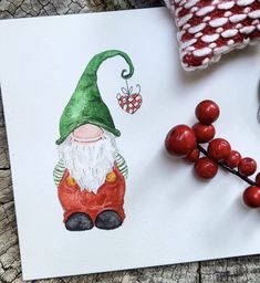 a drawing of a gnome sitting on top of a piece of paper next to berries