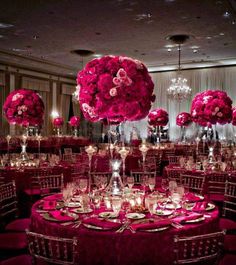 the tables are set up with pink flowers and centerpieces for an elegant event