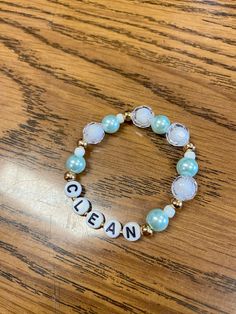 a beaded bracelet with the word ocean written in white letters and blue glass beads