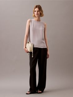 Cut in a relaxed fit, this top has a sleeveless silhouette and a gentle drape. Detailed with a clasp closure at the back. Wear with a pair of tailored pants for effortless styling.  Material: Machine Wash. Tailored Pants, Sleeveless Tank, Sleeveless Tank Top, Calvin Klein, Relaxed Fit, Tank Tops, Top Outfits, Pants, Clothes For Women