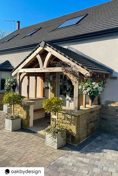 the front of a house with potted plants outside