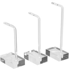 three clear acrylic stands with metal handles