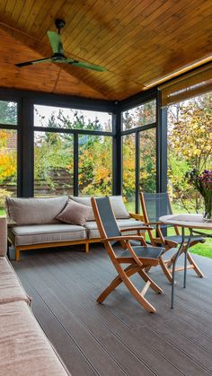 a covered porch with couches and tables on it