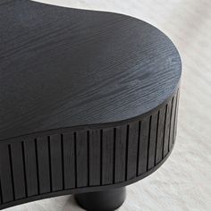 a close up view of the top of a black table with wood graining on it