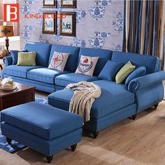 a living room filled with blue couches and pillows