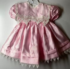 "Beautiful dress fully lined - Trimmed in a dainty white lace - full skirt with a large pre-made bow on back. Only issue a few tiny snags (as seen in last photo) -hardly noticeable - Labeled size 24 months measures pit to pit 9 1/2\"/ length (shoulder to bottom lace) 18\"/ Smoke free environment (122)" Fitted Princess Dress With Lace Trim, Pink Princess Dress With Lace Patchwork, Pink Vintage Victorian Dress For Fancy Dress, Cute Pink Lace Princess Dress, Pink Lace Patchwork Dress For Dress-up, Pink Dress With Lace Patchwork For Dress-up, Lace Princess Dress With Lace Trim For Dress-up, Princess Dress For Dress-up With Lace Trim, Princess Dress With Lace Trim For Dress-up