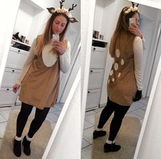 a woman taking a selfie in front of a mirror wearing reindeer ears and holding a cell phone