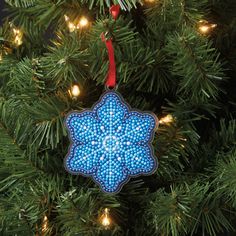 a blue ornament hanging from a christmas tree