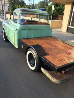 an old pick up truck is parked on the street