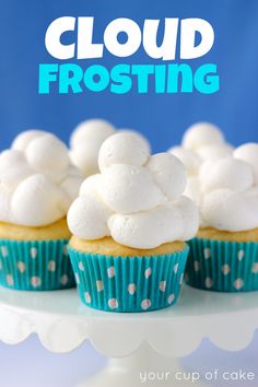 cupcakes with white frosting sitting on a cake stand