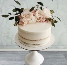 there is a white cake with flowers on top