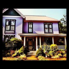 a purple house with black shutters and white trim