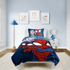 a bedroom with blue walls and spiderman bedding