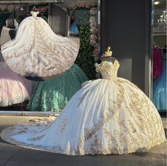 there is a dress on display in front of a store window with other dresses behind it