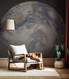 a chair in front of a wall with a view of the earth on it's side