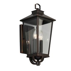 an outdoor wall light with two lights on the front and back of it, one is black