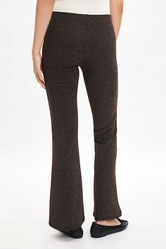 Our best-selling Silence + Noise pant in a standout shimmering knit. Designed with a mid-rise waistline that hits at the natural waist, slim fit though the hips and thighs and kick-flare hem. Find them only at Urban Outfitters. Features Silence + Noise Bella shimmer pull-on knit flare pant Mid-rise trouser Soft and stretchy metallic shimmer knit Mid-rise waistline Slim fit through waist and seat Flare fit Full length Easy pull-on style UO exclusive Content + Care 83% Polyester, 14% fiber, 3% spa Chic Metallic Winter Bottoms, Glamorous Stretch Bottoms For Winter, Glitter Bottoms For Night Out In Winter, Glitter Bottoms For Winter Night Out, Metallic Stretch Bottoms With Elastic Waistband, Metallic Fitted Bottoms For Winter, Elegant Fitted Bottoms With Glitter, Elegant Metallic Bottoms For Winter, Elegant Fitted Shimmer Bottoms