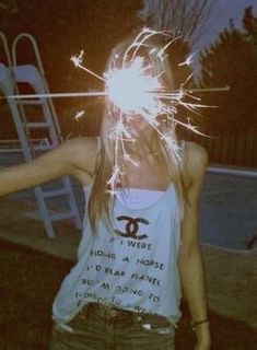 a woman holding sparklers in her hands