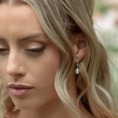 a close up of a person wearing earrings