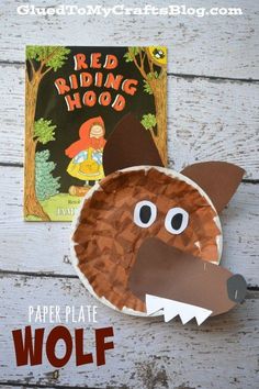 the paper plate wolf is next to a red riding hood book