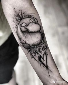 a man's arm with a black and white tattoo design on the left forearm