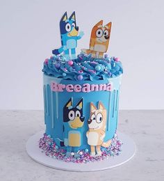 a blue cake with cartoon characters on it