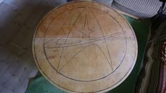 a wooden table sitting on top of a green rug