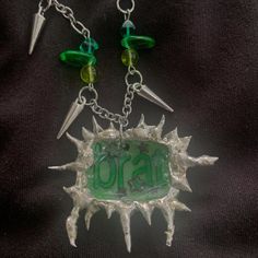 Please note there are two options for this necklace. You can choose a simple chain with no beads, so it will just be the brat charm. The second option is to get the pendant with green beads and spikes on the chain. You can see the difference in the photos. Message me if you have any questions! Made from lead free solder. (Shrinky dink made by @sweet.fea.studios on IG) Green Metal Necklace With Charms, Green Metal Necklaces With Charms, Green Nickel-free Pendant Charm Necklace, Green Metal Pendant Charm Necklaces, Brat Necklace, Soft Solder, Soldered Pendants, Wood River, Shrinky Dink