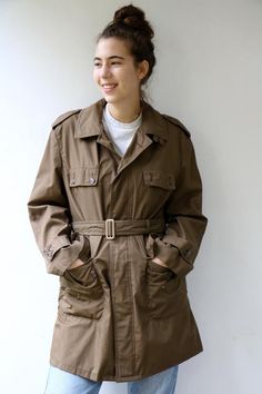 Vintage trench coat in brown khaki military-style, short length, original belt attach, pockets, buttons down the front- upper button is missing, original tag intact, fully lined in gold satin. aside from minor signs of wear, very good vintage condition clean ready to wear.   The model is 5'8" and size S/M for reference.Tag size: 48 Approximate size: O.S- please refer to the measurementsM E A S U R E M E N T S -were taken with garments laying flat, please double where necessary.————————————♥————B Vintage Olive Outerwear For Work, Khaki Belted Utility Outerwear, Vintage Belted Workwear Outerwear, Vintage Belted Outerwear For Work, Brown Military Style Outerwear For Work, Chunky Sweater Dress, Mustard Jumpsuit, Hippy Dress, Trench Coat Vintage