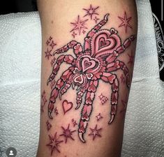 a spider with hearts and stars on it's legs is seen in this tattoo