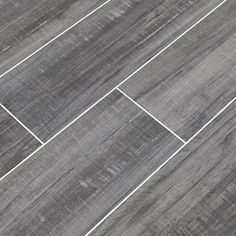 a tile floor with grey and white lines on the top, in an angle view