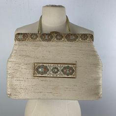 "Wonderful vintage purse from the 1960s to wear with that Jackie O dress and coat. White raw silk with brocade trim & gold hardware including a chain handle. Measures: 14\" long 10\" high 2\" deep hand drop of 7\" Pink satin lining with 2 interior pockets -one zips. Designed by Faye Mell Designs and from Fox's Miami Beach. Sale supports Vermont's PuppeTree. Thank you & please check our Etsy Store." Vintage Rectangular Evening Bag For Luncheon, Vintage Rectangular Evening Bag, Vintage Bags With Gold-tone Hardware, Vintage Rectangular Evening Bag For Formal Occasions, Vintage Rectangular Formal Evening Bag, Mid-century Gold Evening Bag, Vintage Beige Party Bag, Elegant Rectangular Evening Bag For Luncheon, Vintage Wedding Bags With Gold Embroidery