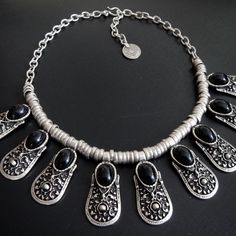 The Black Lace necklace combines silver-plated beading with ornate pendants featuring polished black stones and an adjustable hook and loop closure. Makes an elegant set when paired with matching Black Lace earrings, bracelet & ring. Black Lace Necklace, Black Stones, Lace Necklace, Lace Earrings, Bracelet Ring, Elegant Sets, Turkish Towels, Black Stone, Hook And Loop