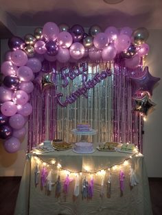 a table topped with lots of purple balloons