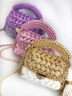 four woven purses sitting on top of each other