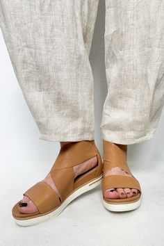 A sandal with the soul of a sneaker. With a molded footbed and crisscross straps in soft tumbled leather. Rubber outsole for comfort, flexibility and traction. 1-inch heel, 1-inch platform; molded footbed for added support. Open toe, wedge heel, cross strap styling. Back zipper entry. Padded toe, arch and heel for comfort; leather lining. Item# EF39477K *All sale items are final sale. Click to see our full return policy here. Sport Sandals, Sandals For Sale, Cross Straps, The Soul, Wedge Heels, Criss Cross, Sale Items, Open Toe, Final Sale